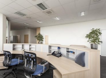 Empty UAE company reception desk with two office chairs and a business phone
