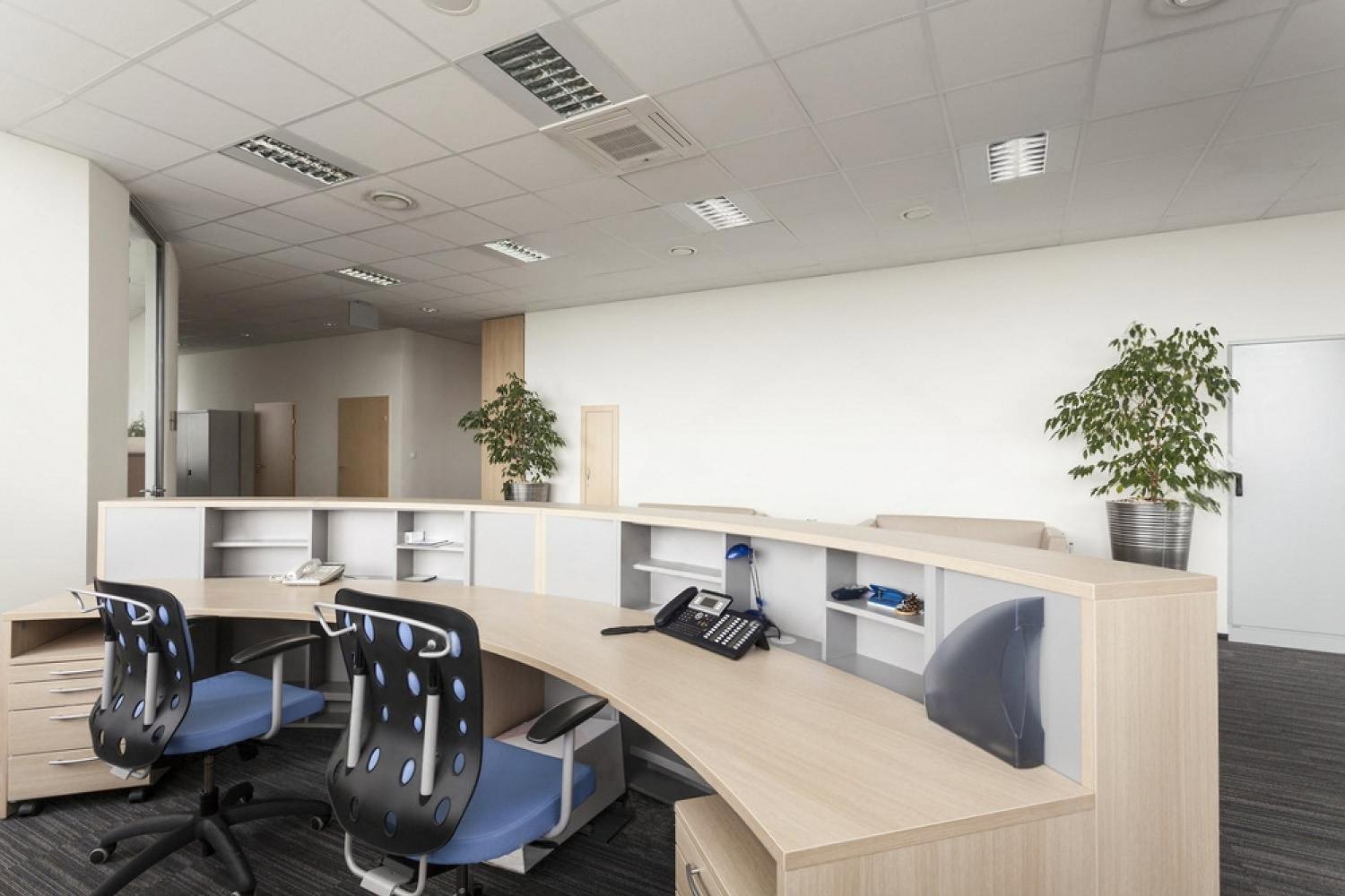 Empty UAE company reception desk with two office chairs and a business phone